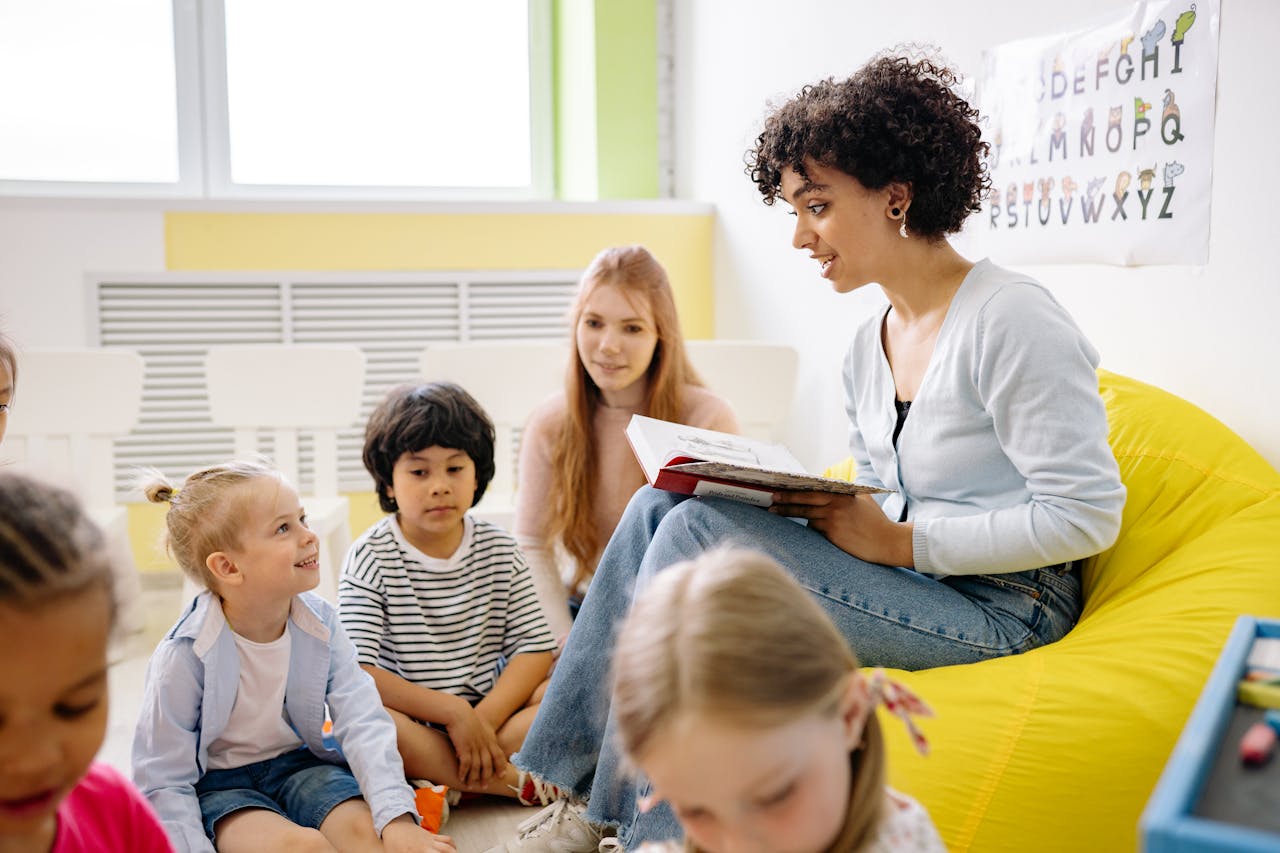 Services Teacher reading to preschool kids in a colorful classroom setting.